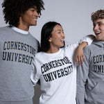 Three people wearing 'Cornerstone University' sweatshirts against a plain background