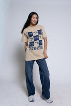Load image into Gallery viewer, Woman wearing a beige t-shirt with a blue mascot checkered design and &#39;Cornerstone&#39; text.