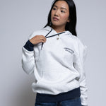 Woman wearing a light hoodie with 'Cornerstone University' printed on it