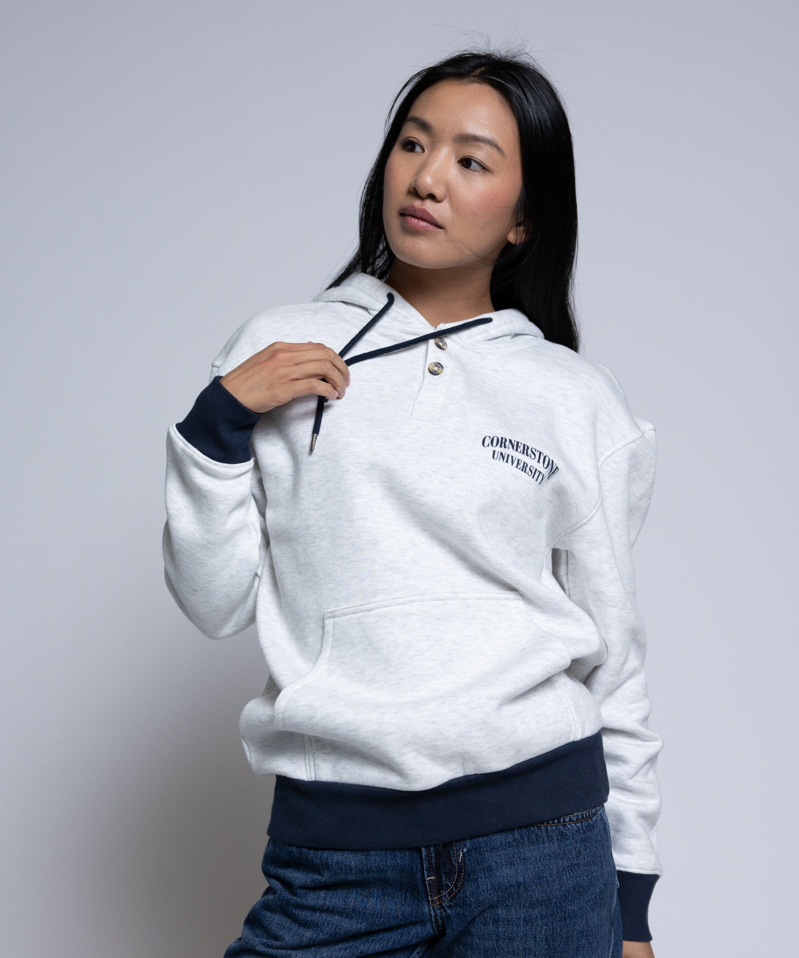 Woman wearing a light hoodie with 'Cornerstone University' printed on it