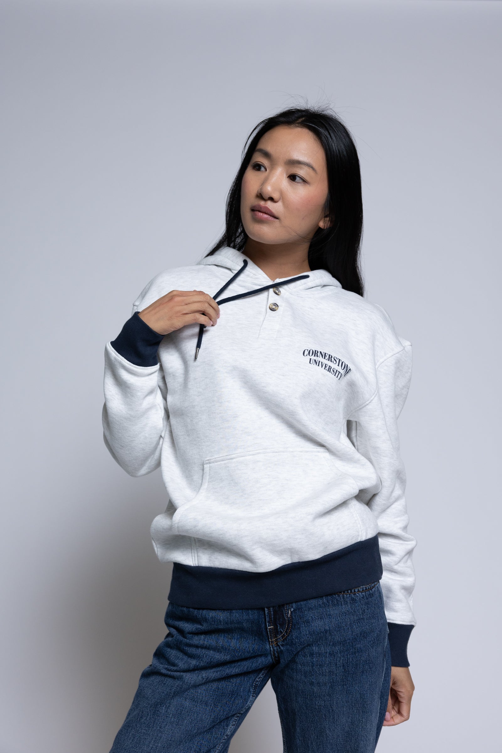 Woman wearing a light hoodie with 'Cornerstone University' printed on it