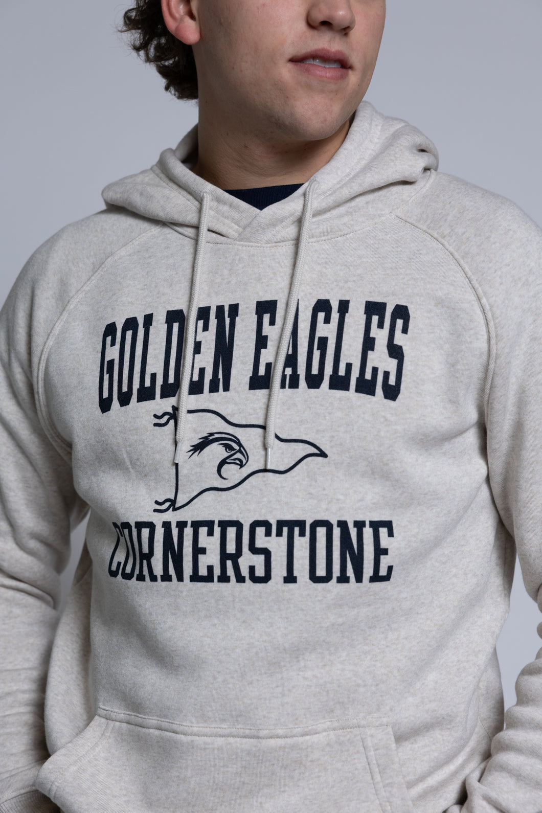 Person wearing a hoodie with 'Golden Eagles Cornerstone' text and logo.