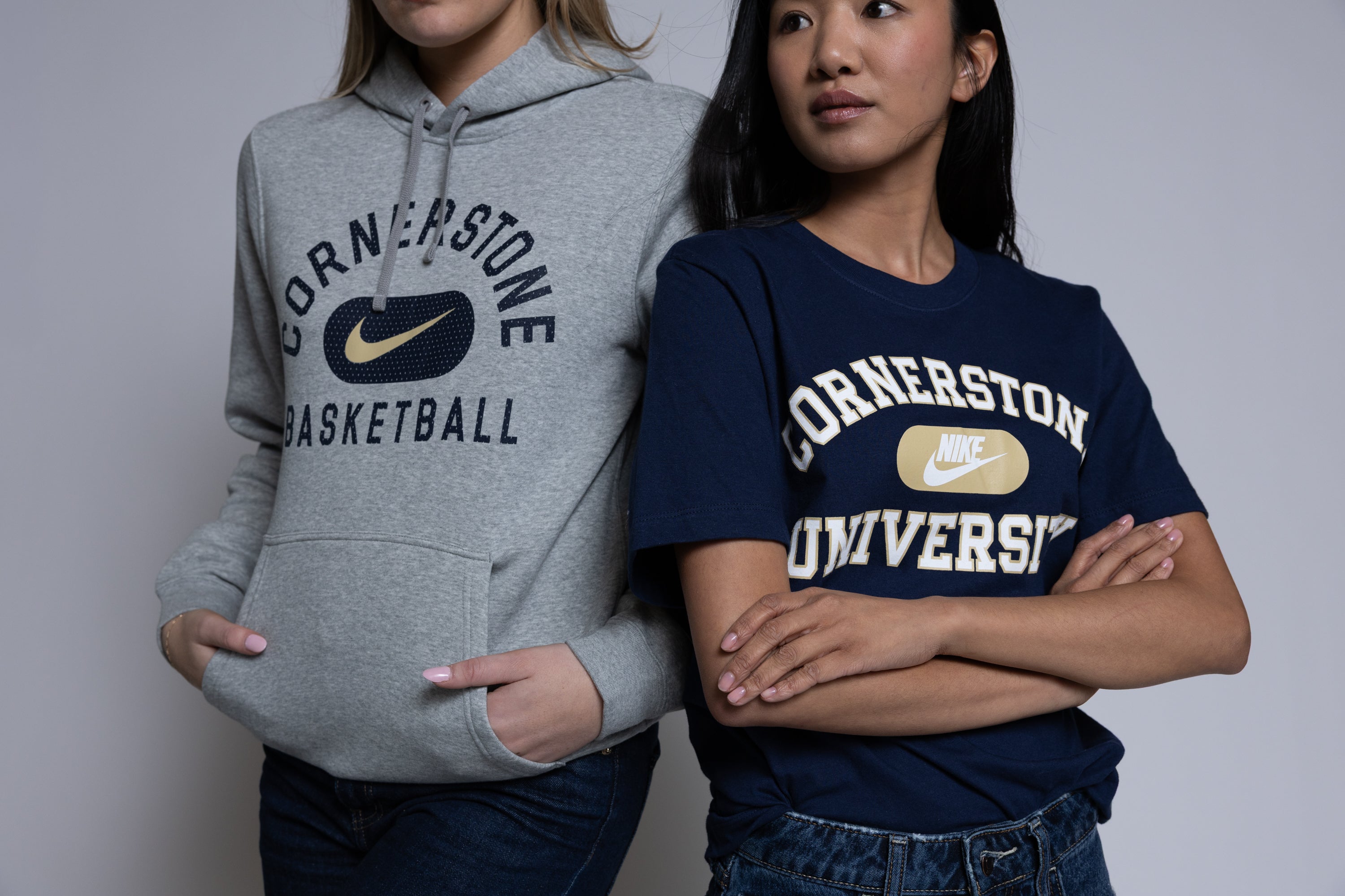 Two people wearing 'Cornerstone Basketball' hoodie and 'Cornerstone University' t-shirt against a plain background