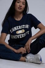 Load image into Gallery viewer, Person wearing a navy blue t-shirt with &#39;Cornerstone University&#39; text, sitting on a light background