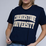Woman wearing a navy blue t-shirt with 'Cornerstone University' text on a plain background