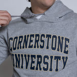 Person wearing a gray hoodie with 'Cornerstone University' printed on it.