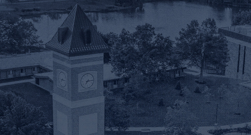 Areal view of clock tower with buildings in the background